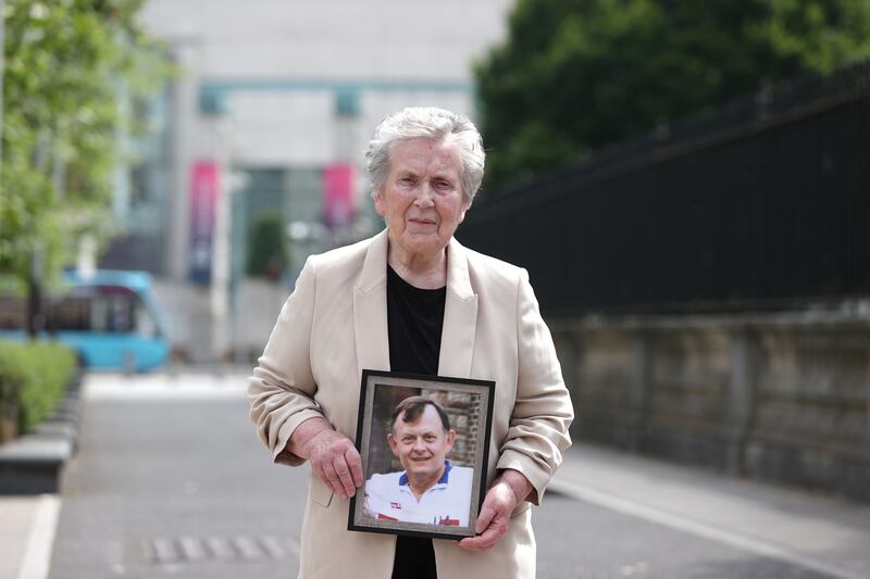 Bridie Brown, the widow of murdered GAA official Seán Brown, holds a picture of him outside the Royal Courts of Justice in Belfast on Tuesday. Photograph: Liam McBurney/PA Wire