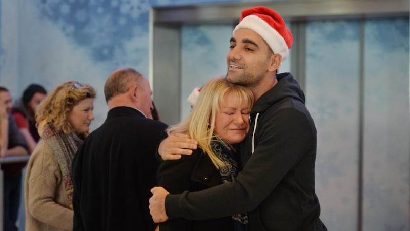 Sean Delavari embraces his mother Carol after his arrival from Townsville, Australia at Dublin Airport for Christmas. Photograph: Alan Betson/The Irish Times