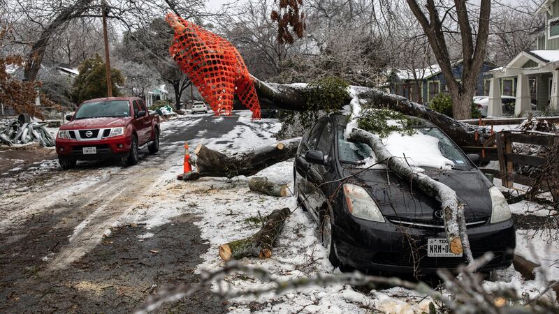 A fallen tree  in Austin, Texas, damaged a vehicle. A winter ice and snow storm also left people without electricity and running water. Photograph: Tamir Kalifa/The New York Times