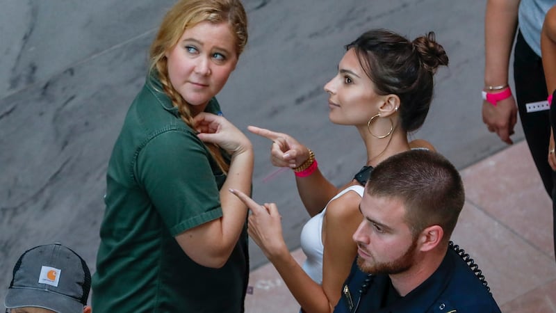 Amy Schumer (left)) and US actress Emily Ratajkowski (right) gesture after getting detained along with hundreds of other protestors. Photograph: EPA