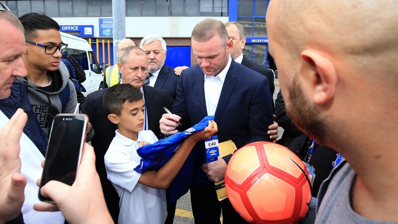 Wayne Rooney signs autographs outside Goodison Park. Photograph: Nigel french/PA