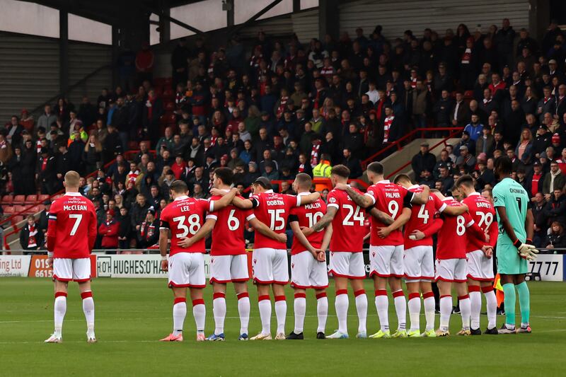 James McClean of Wrexham stood away from his team-mates during the Rememberance Day's minute’s silence before the Sky Bet League One match against Mansfield Town at Wrexham. Photograph: Gary Oakley/PA 