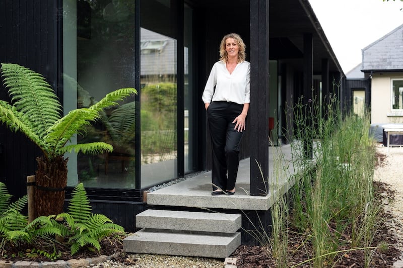 A charred black ash extension with veranda, adjoining the main house