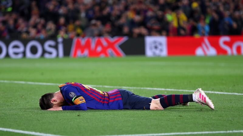 Lionel Messi collapses at full time after Barcelona’s 3-0 win over Liverpool. Photograph: Catherine Ivill/Getty