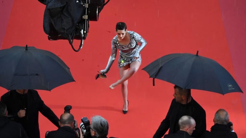 Shoe news: Kristen Stewart removes her Louboutins in Cannes. Photograph: Antonin Thuillier/AFP/Getty