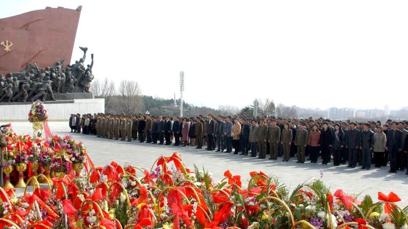 North Korean soldiers, workers and students stand before the statues of North Korean founder Kim Il-sung and his son, late leader Kim Jong-il, on the 101st anniversary of Kim Il-sung's birth, at Mansudae in Pyongyang today