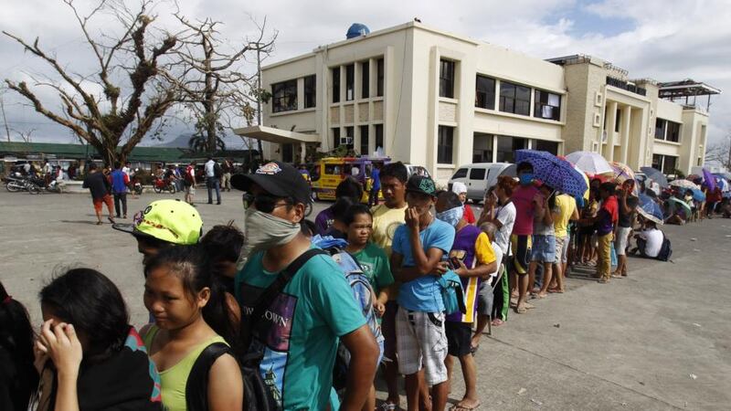 Typhoon survivors queue up to charge their mobile phones at a generator provided for by the government in Tacloban city in central Philippines. Photograph: Edgar Su/Reuters.