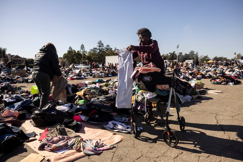 Evacuees from the Eaton fire among heaps of clothes at a donation centre in Santa Anita Park, Arcadia, California. Photograph: Etienne Laurent/AFP via Getty Images