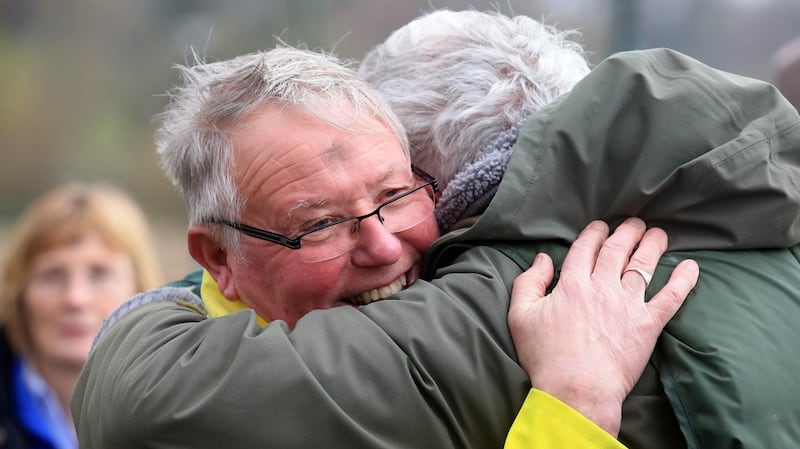 Local volunteers Brian McManus and Pat Lunny embrace after news that a body was recovered from Lough Erne. Photograph: John McVitty