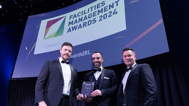 Des Sheridan, hire manager of Karcher Ireland, presents the cleaning service provider of the year – TFM award to Eddie O'Sullivan and Kieran Fitzgerald, MCR Group