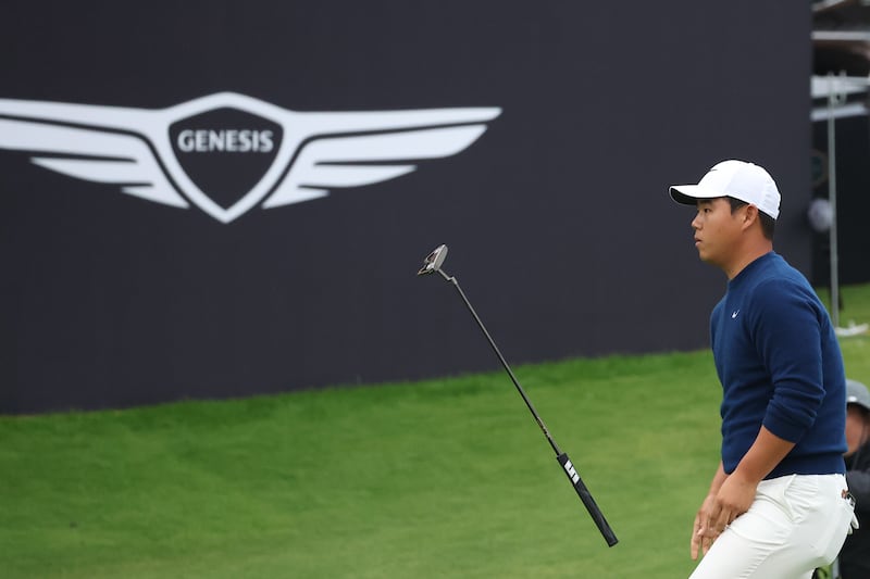 Tom Kim of South Korea reacts to missing his birdie putt on the 18th green. Photograph: Chung Sung-Jun/Getty