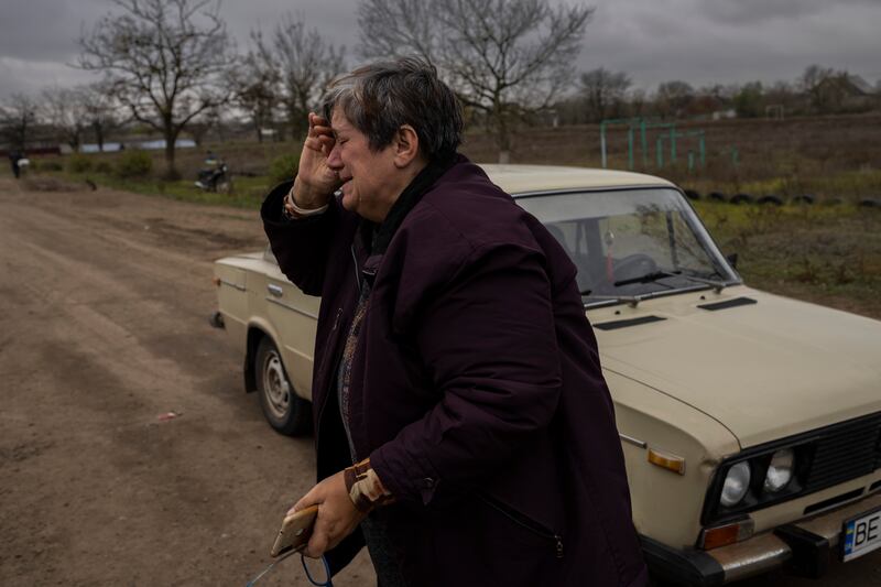 Elena Skalskya enters her village of Tsentralne for the first time since Russian troops withdrew from the Kherson region. Photograph: Bernat Armangue/AP/PA