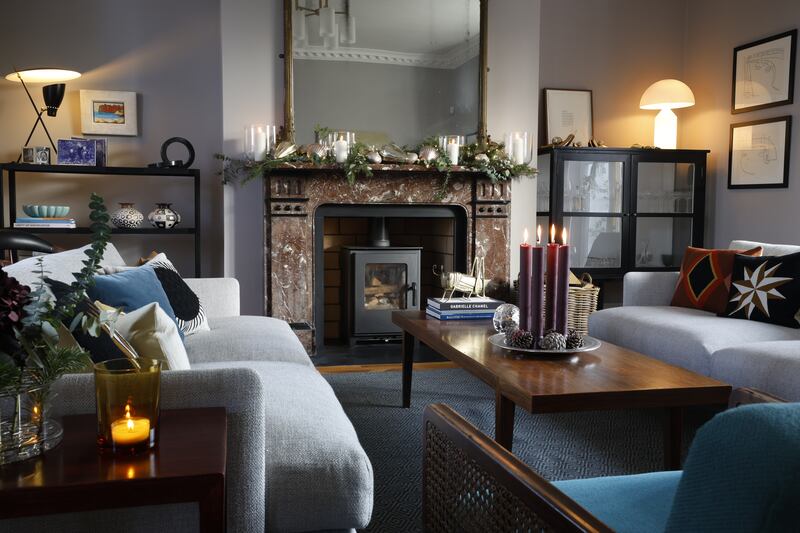 The mantle features oversize baubles and lanterns from Nordic Elements, and foliage by Appassionata Flowers. Photograph: Nick Bradshaw