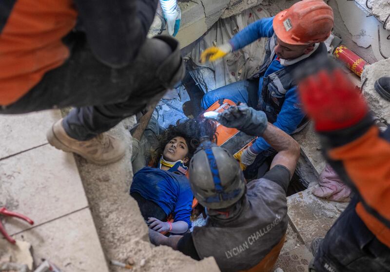 Emergency personnel work to rescue 16-year-old Melda from the rubble of a collapsed building in Hatay, southern Turkey. Photograph:  Bulent Kilic/Getty Images