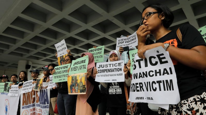 A migrant workers alliance group holds placards to protest the killings of two Indonesian women in 2014 outside the High Court in Hong Kong, Monday, October 24th, 2016. Photograph:  Vincent Yu/AP