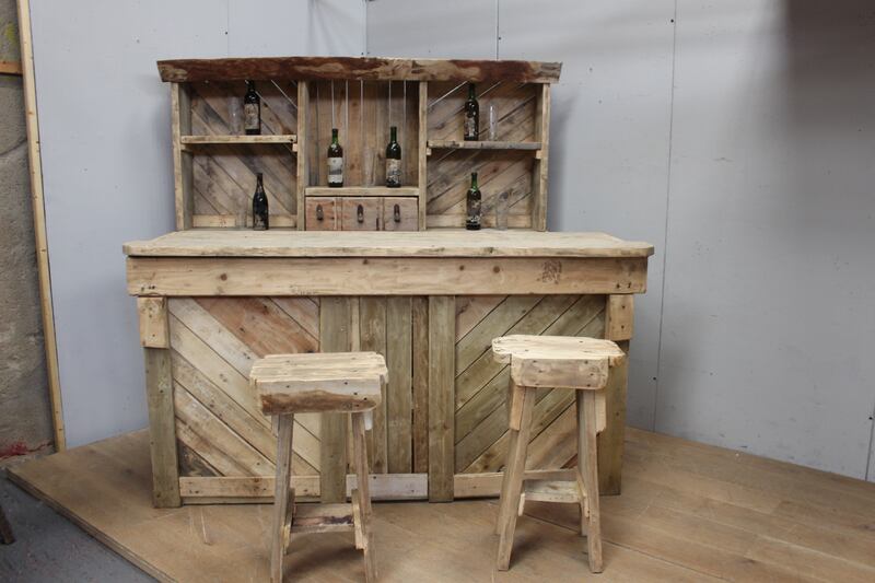 Rough-hewn wooden bar with stools, €900-€1,200 from Victor Mee