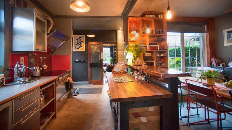 The kitchen/dining room has an industrial-style stove and a Waterford Stanley cooker.