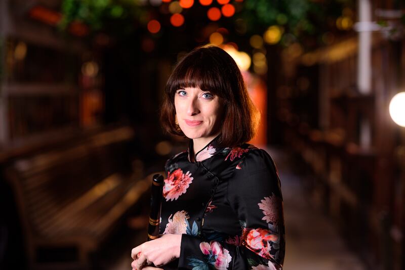 Aoife wearing floral dress, looks directly at camera