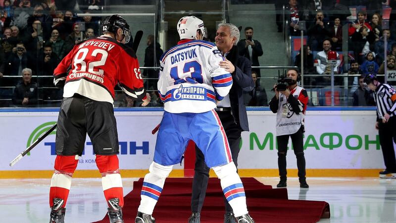 Jose Mourinho  is helped up from his fall by SKA Petersburg captain Pavel Datsyuk. Photograph: AFP/Getty Images