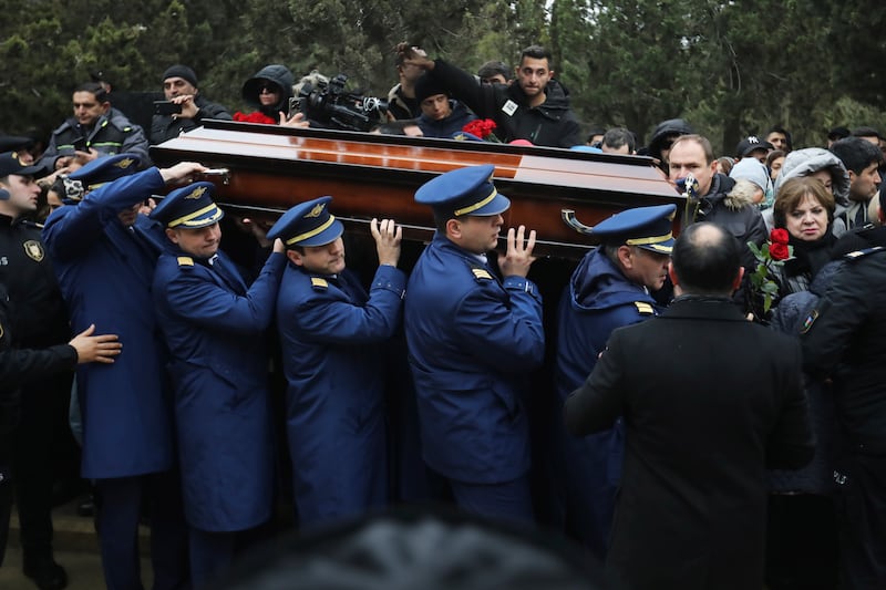 Pilots carry a coffin during a funeral of a crew member of the Azerbaijan Airlines plane. Photograph: AP Photo