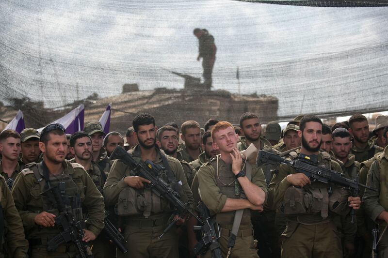 Israeli soldiers stand as they wait for a meeting with Israeli Minister of Defence Yoav Gallant on the Israeli border with the Gaza Strip on Thursday in Sderot, Israel. Photograph: Amir Levy/Getty Images