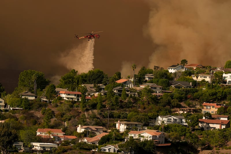 Water is dropped on homes as the Palisades fire advances. Photograph: Jae C Hong/AP