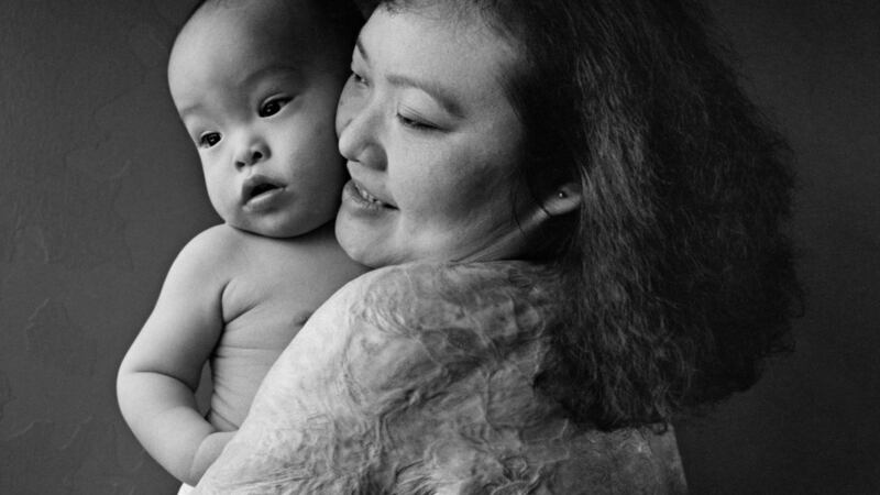 Kim Phuc pictured with her son Thomas, now aged 22, in 1995. ‘When I was growing up, the pain was so sharp, it was like I’d been cut by a knife. As I get older, the pain is different, it is deep in there and stays there.’