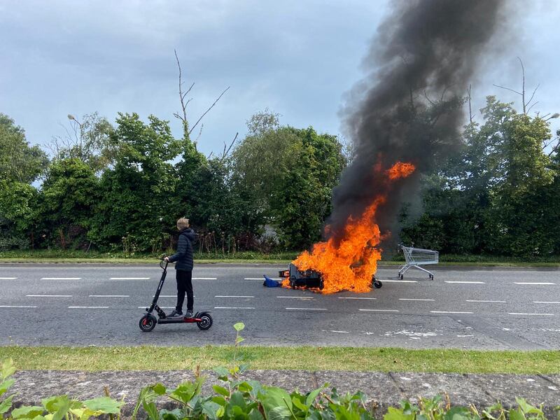 The scene outside the former Crown Paints factory in Coolock. A number of fires have been lit at the site of the former Crown Paints factory in Coolock where work was due to begin this week. Photograph: Dara Mac Donaill / The Irish Times