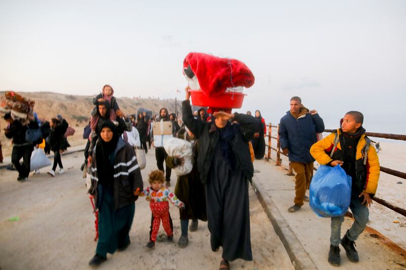 Palestinians walk along Gaza's Al-Rashid coastal road to northern Gaza on Monday.  Photograph: Youssef Alzanoun/Middle East Images/AFP via Getty Images