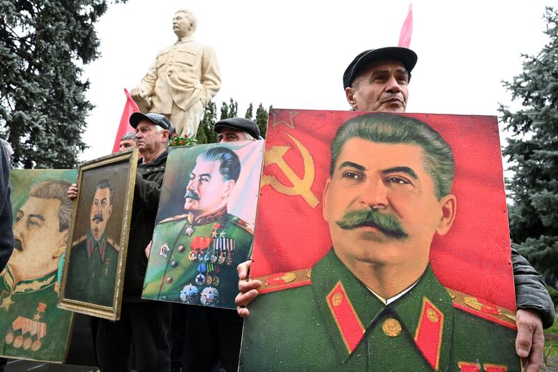 Supporters of Joseph Stalin carry portraits of the late Soviet leader during a ceremony to mark the 70th anniversary of his death in his hometown of Gori, Georgia, in 2023. Photograph: Vano Shlamov/AFP/Getty