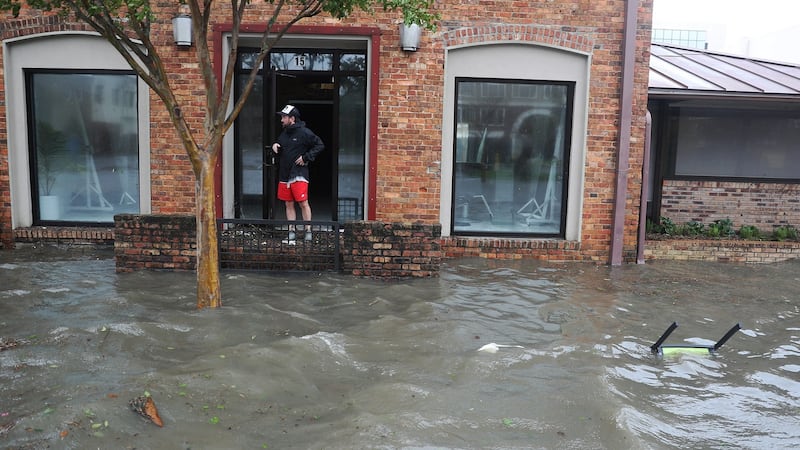 Hurst Butts looks out at a flooded street in front of his business as Hurricane Sally passes through the area on Wednesday in Pensacola, Florida.  Photograph:  Joe Raedle/Getty Images