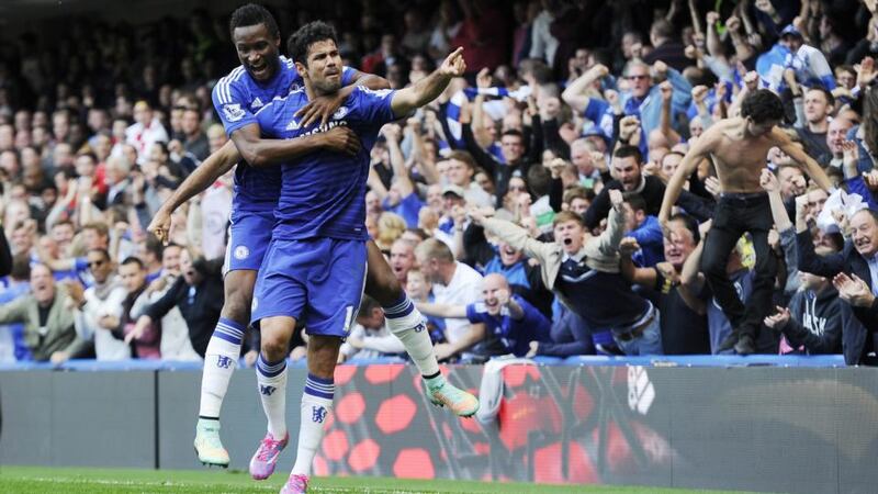 Chelsea’s Diego Costa  celebrates with John Obi Mikel after scoring his side’s goal during the  Premier League soccer match against Arsenal at Stamford Bridge. Photograph:   Facundo Arrizabalaga/EPA