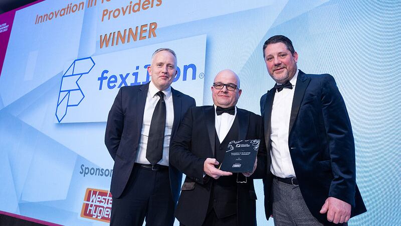 Martin Conneely, customer success representative and chemical lead at Western Hygiene, presents the Innovation in Technology and Systems - Providers award to George Harold and Kieran Beggan, Fexillon.