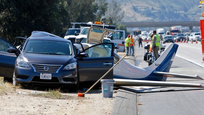 The plane struck the back of a car, resulting in the death of a woman in the car.  Photograph: Don Boomer/San Diego Union-Tribune/AP