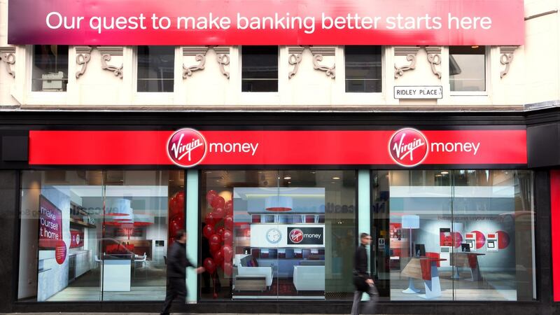 Pedestrians pass a Virgin Money high street bank in Newcastle. The lender is subject to a takeover bid from CYBG, which is led by former AIB chief David Duffy. Photograph: Bloomberg