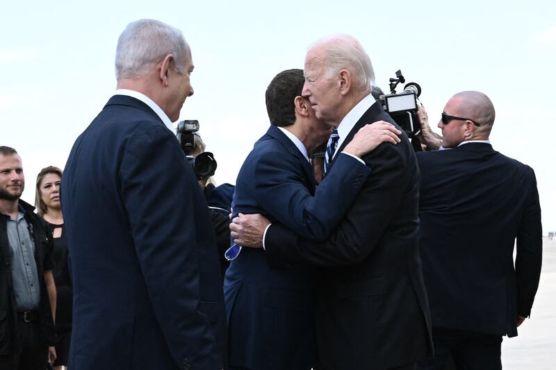 Israeli prime minister Binyamin Netanyahu (L) looks on as Israeli president Isaac Herzog greets US president Joe Biden at Tel Aviv's Ben Gurion airport. Photograph: BRENDAN SMIALOWSKI/AFP via Getty Images