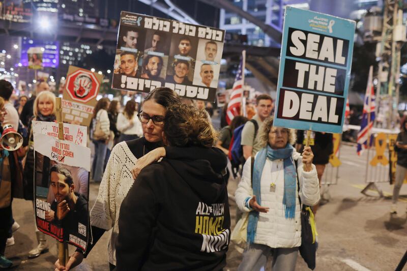 Protesters hug in response to reports of a ceasefire agreement during a protest calling for the release of the hostages in Gaza in Tel Aviv. Photograph: Avishag Shaar-Yashuv/New York Times
                      