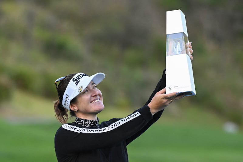 Hannah Green lifts the trophy after her victory at the BMW Ladies Championship at Seowon Valley Country Club in Paju. Photograph: Jung Yeon-je/AFP