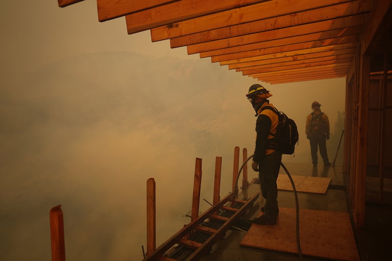 Firefighters monitor the advance of the Palisades fire in Mandeville Canyon. Photograph: Eric Thayer/AP