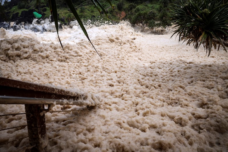 Sea foam pushed by record-breaking waves caused by the outer fringe of Cyclone Alfred at Point Danger in Coolangatta. Photograph: David Gray/AFP