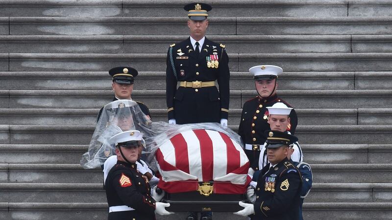 A military honour guard carries the casket of US senator John McCain from the US Capitol in Washington. Photograph:  Nicholas Kamm/AFP/Getty Images