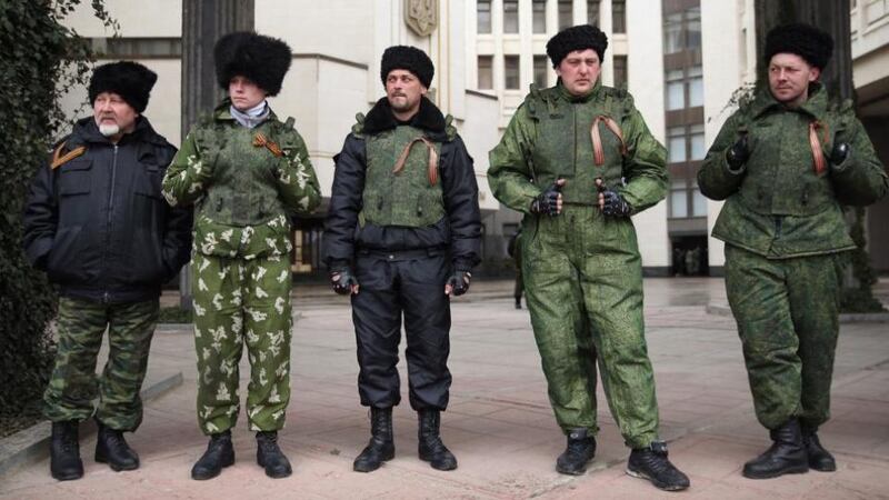 Cossacks stand guard at the entrance to the Crimean parliament building in Simferopol, Ukraine, yesterday. Photo by Sean Gallup/Getty Images