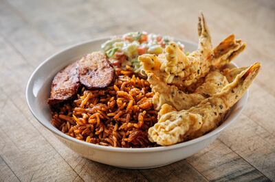 African-style shrimp bowl with Jollof rice, plantain and coleslaw.