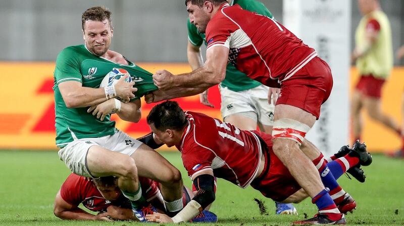 Jack Carty is tackled by Vasily Artemyev and Tagir Gadzhiev (R) during Ireland’s win over Russia. Photograph: Dan Sheridan/Inpho