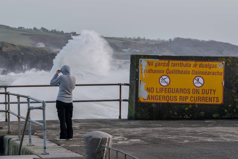 A woman watches as waves crash into the rocks at Rosscarbery, west Cork, during Storm Éowyn. Photograph: Andy Gibson.