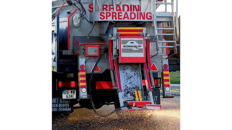 A man walks on the Bregagh Road at Stranocum, Co Antrim, yesterday as the big freeze continues. Photograph: Stephen Davison/PA Below: A truck spreading grit in Greystones, Co Wicklow, yesterday.