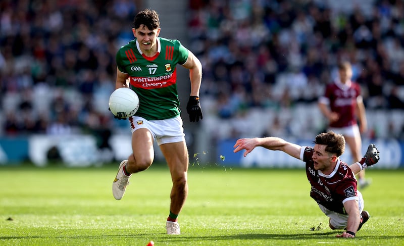 Galway's Cathal Sweeney clutches in vain at Mayo's Tommy Conroy. Photograph: Ryan Byrne/Inpho 