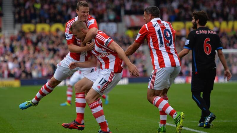 Ryan Shawcross of Stoke (centre) celebrates scoring with Robert Huth (left) and Jonathan Walters at Britannia Stadium. Photograph:  Christopher Lee/Getty Images