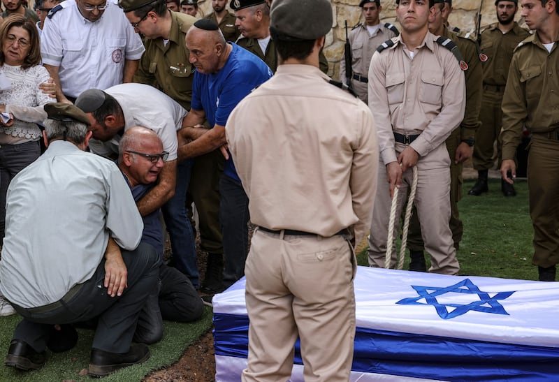 The father of French-Israeli soldier Eli Valentin Ghenassia, who was killed in combat at Kibbutz Beeri during an infiltration by Hamas militans, mourns during his funeral in the Mount Herzl cemetery in Jerusalem. Photograph: Ronaldo Schemidt/AFP via Getty Images