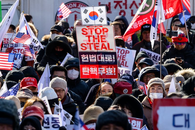 Supporters of South Korean president Yoon Suk Yeol attend a rally near the central district court in Seoul on Thursday, as the ousted leader became the country's first sitting head of state to stand trial in a criminal case as hearings opened on his bid to impose martial law. Photograph: Anthony Wallace/AFP via Getty Images